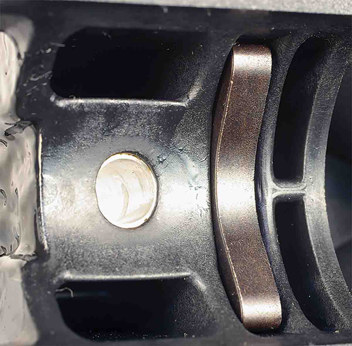 The recoil lug is anchored in the stock and attaches to a cut in the bottom of the receiver ring.